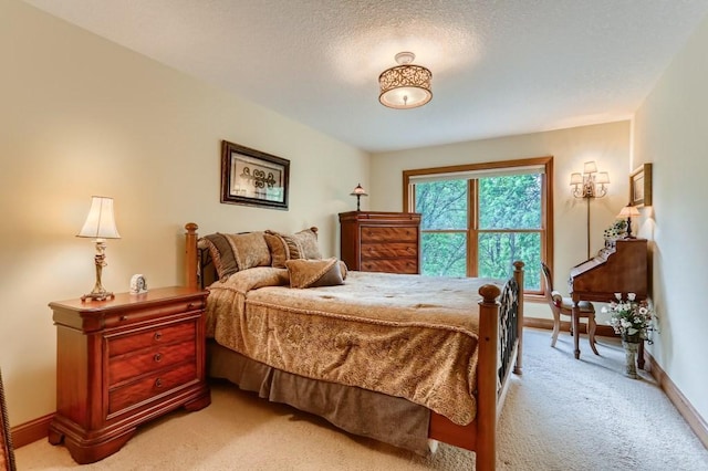 bedroom featuring light colored carpet and a textured ceiling