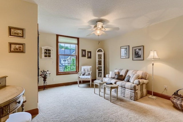 carpeted living room featuring a textured ceiling and ceiling fan