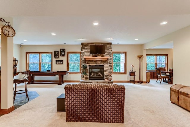 carpeted living room with a wealth of natural light and a fireplace