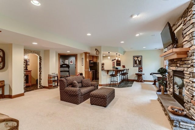 living room with light carpet and a fireplace