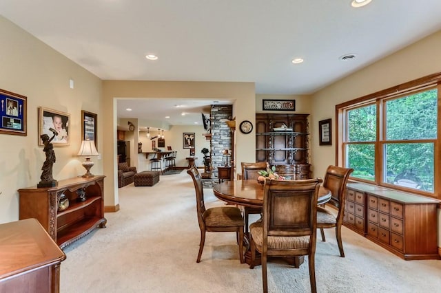 dining space featuring light colored carpet