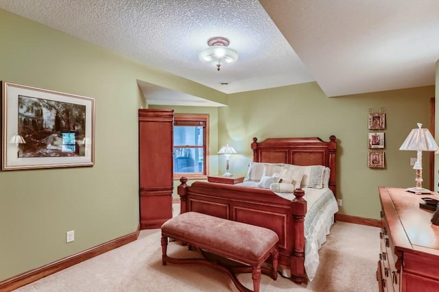 bedroom featuring light carpet and a textured ceiling