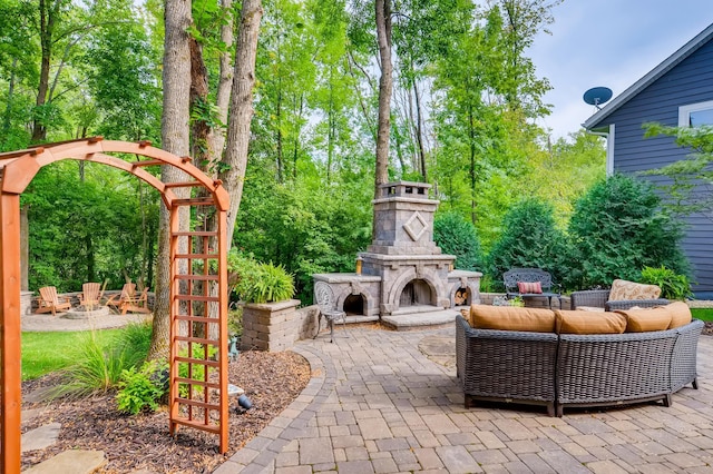 view of patio with an outdoor living space with a fireplace