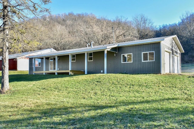 view of front of home with a front yard, a garage, and covered porch