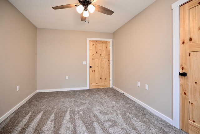 spare room featuring ceiling fan and carpet floors