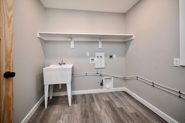 clothes washing area featuring electric dryer hookup, hookup for a gas dryer, hookup for a washing machine, and hardwood / wood-style flooring