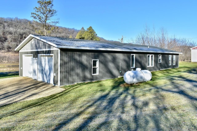 view of outbuilding featuring a garage and a lawn