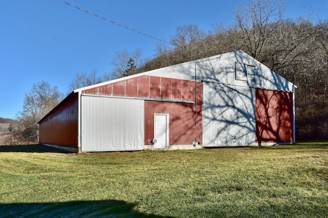 view of outdoor structure featuring a lawn