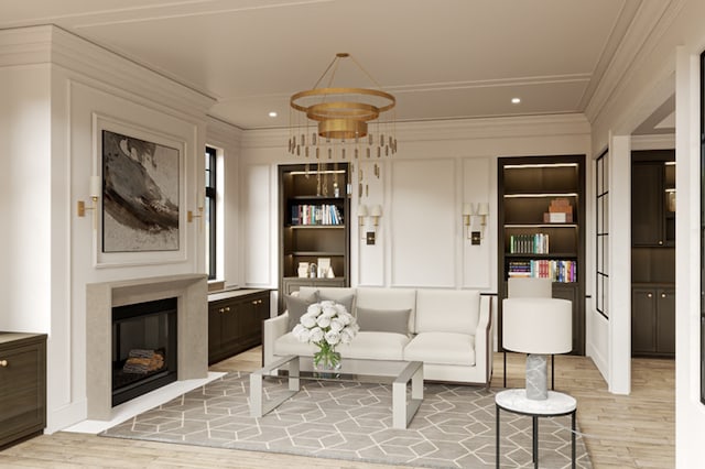 living room with built in shelves, crown molding, and light hardwood / wood-style flooring