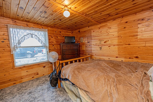 bedroom with ceiling fan, wooden ceiling, carpet floors, and wooden walls