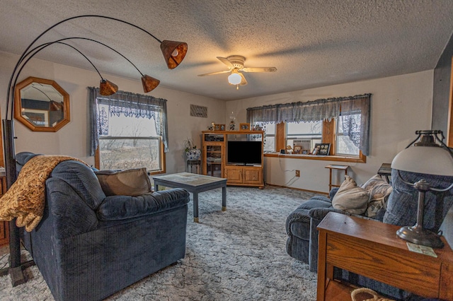 carpeted living room with a textured ceiling and ceiling fan