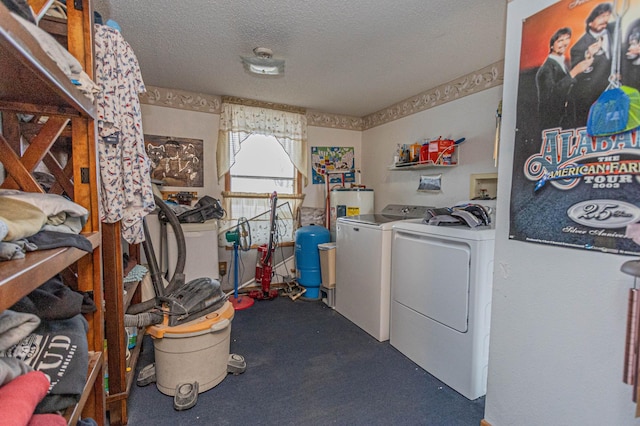 laundry area featuring electric water heater, carpet floors, a textured ceiling, and independent washer and dryer