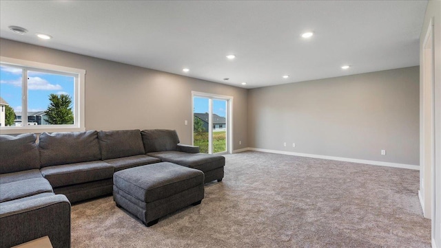 living room with plenty of natural light and light colored carpet