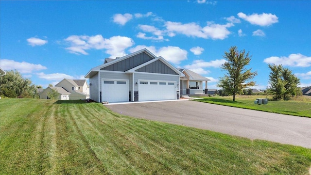 view of front of house with a garage and a front lawn