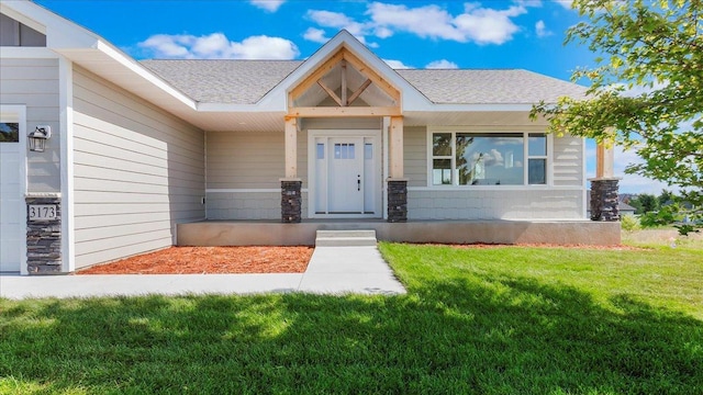 doorway to property featuring a lawn