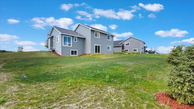 rear view of house featuring a yard