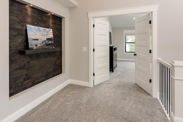 hall featuring light colored carpet