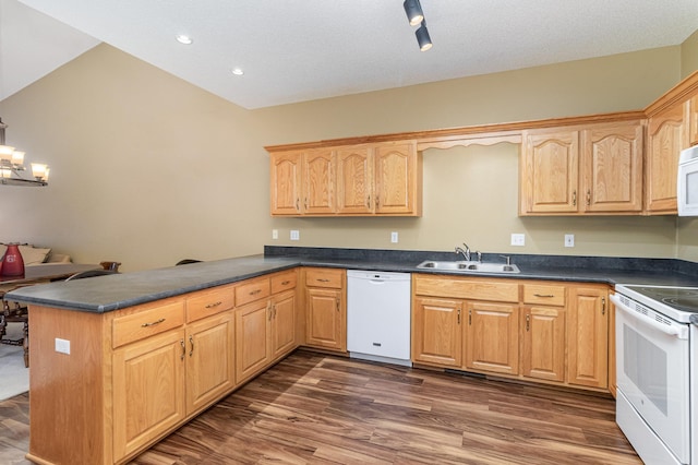 kitchen with kitchen peninsula, white appliances, dark hardwood / wood-style flooring, a chandelier, and sink