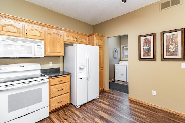 kitchen with washer / dryer, light brown cabinets, white appliances, dark wood-type flooring, and a textured ceiling