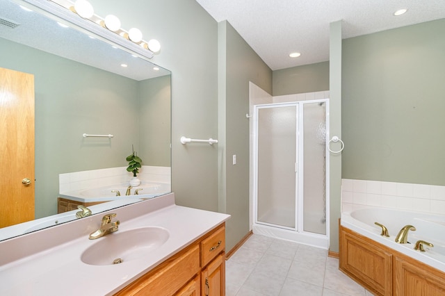 bathroom with a textured ceiling, shower with separate bathtub, vanity, and tile patterned flooring