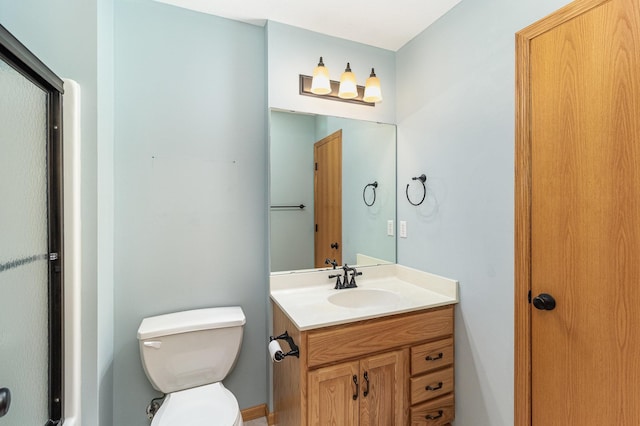 bathroom featuring toilet and vanity