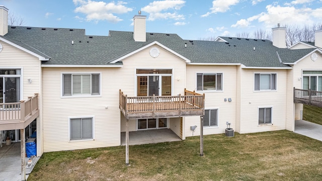 back of house with central AC unit, a deck, a yard, and a patio