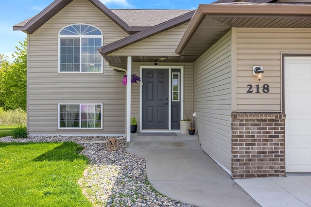 property entrance featuring a lawn