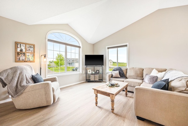 living room with light wood-type flooring and vaulted ceiling