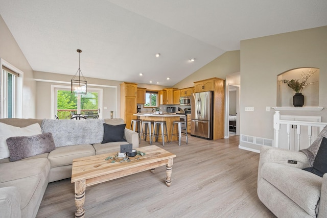 living room featuring light hardwood / wood-style floors and lofted ceiling