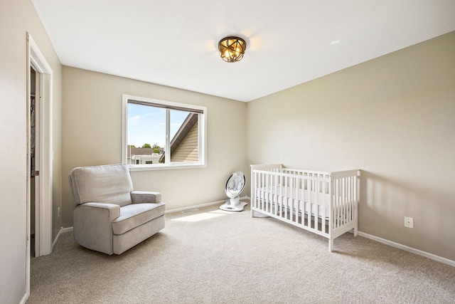 carpeted bedroom featuring a nursery area