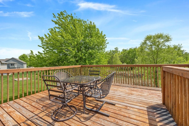 wooden terrace with a lawn