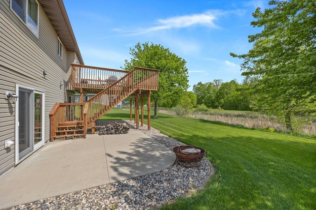 view of yard with a patio, a deck, and an outdoor fire pit