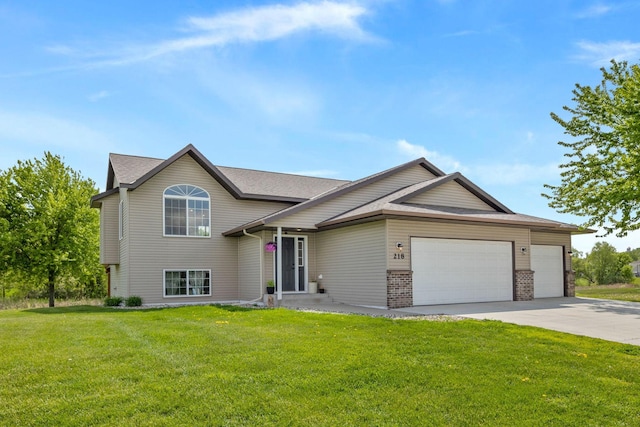 view of front of home with a front lawn and a garage