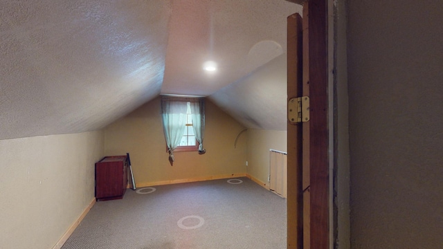 bonus room with carpet, a textured ceiling, and vaulted ceiling