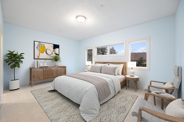 bedroom with light carpet and a textured ceiling