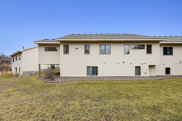 rear view of property with a lawn