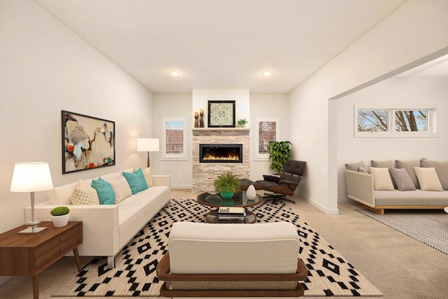 living room with a fireplace and light colored carpet