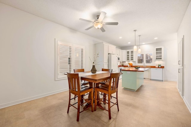 dining room with recessed lighting, ceiling fan, baseboards, and a textured ceiling