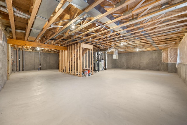 unfinished below grade area featuring water heater