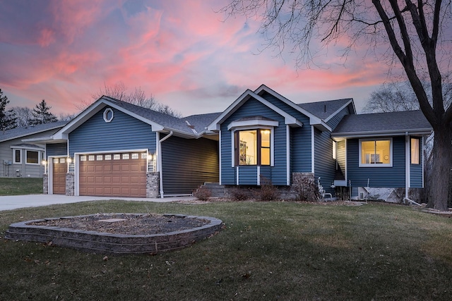 view of front of home featuring a garage and a yard