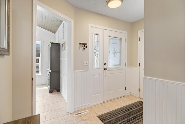 tiled entrance foyer featuring a wealth of natural light