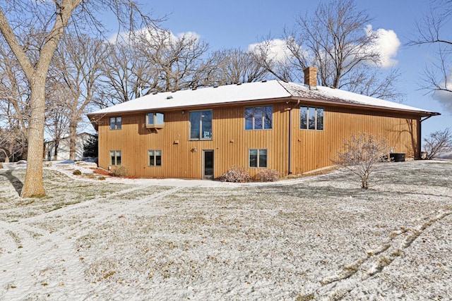 view of snow covered rear of property