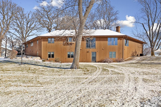 view of snow covered rear of property