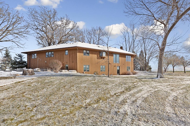 view of snow covered rear of property