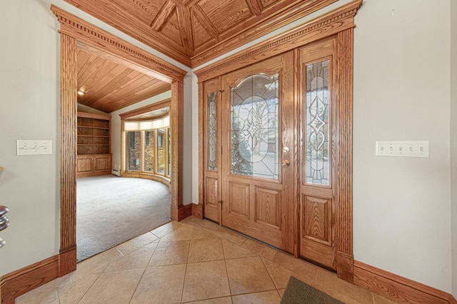 tiled foyer featuring ornamental molding, lofted ceiling, and wood ceiling