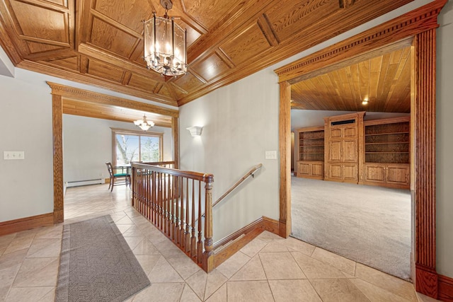 hallway with ornamental molding, light colored carpet, wooden ceiling, and an inviting chandelier