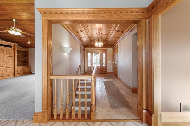 hall featuring vaulted ceiling, wooden ceiling, light carpet, and ornamental molding