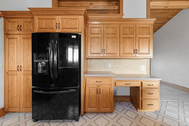 kitchen with black fridge with ice dispenser