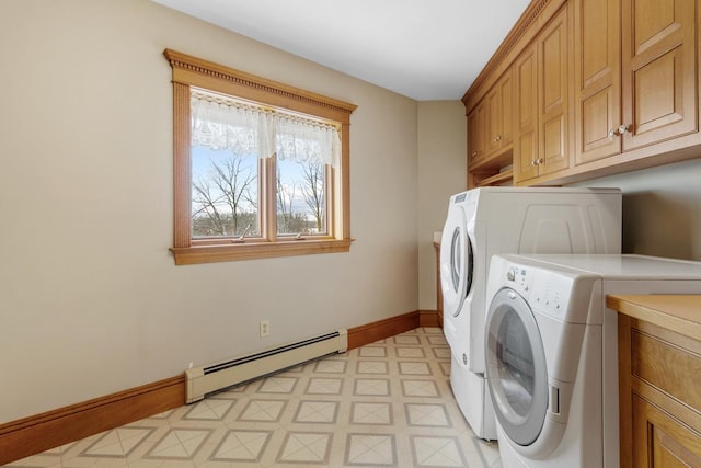 laundry area with separate washer and dryer, cabinets, and a baseboard heating unit