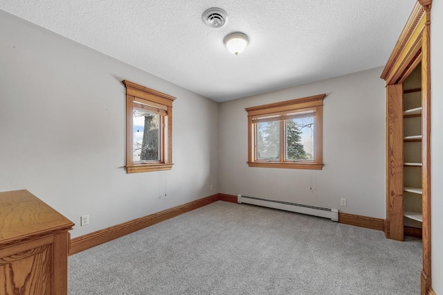 unfurnished bedroom featuring a textured ceiling, a baseboard radiator, and light colored carpet